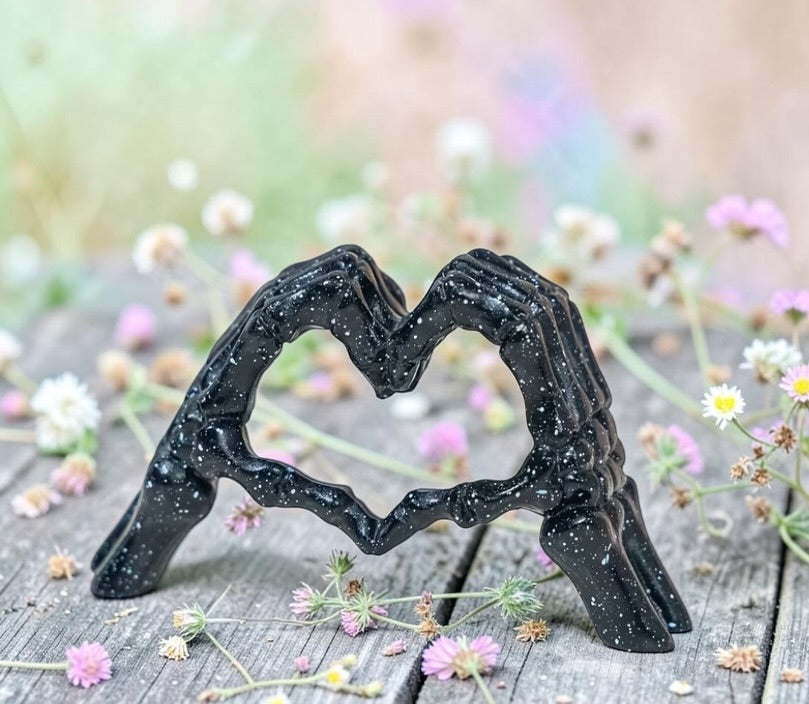 Skeleton hands in heart ornament